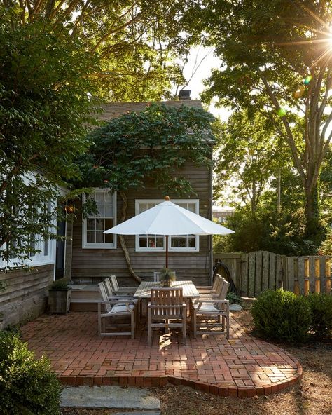 A manicured backyard—complete with a simple brick patio and contemporary teak furnishings—is great for entertaining in the summer months, though the couple will live in the home year-round. Exterior, Patio Ideas, Back Garden Landscaping, Backyard Patio Designs, Small Brick Patio, Small Backyard Patio, Backyard Patio, Brick Patios, Backyard Landscaping