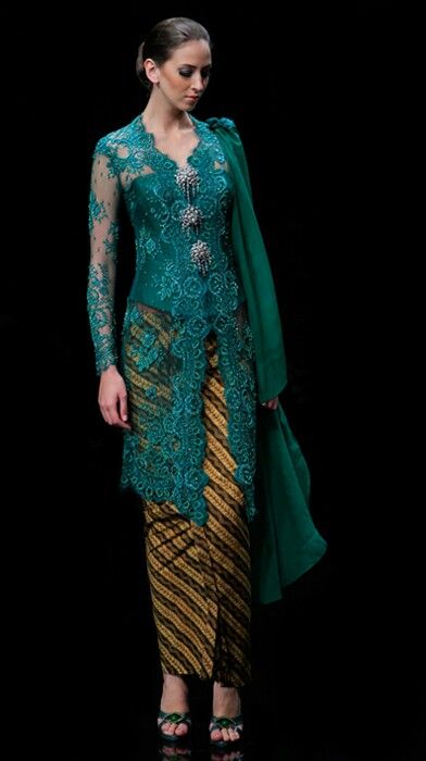 A traditional blouse-dress combination that originates from Indonesia. Kebaya Modern Dress, Kebaya Dress, Kebaya Lace, Baju Kurung, Kebaya Indonesia, Kebaya Wedding, Kebaya Hijab, Kebaya Brokat, Indonesian Kebaya