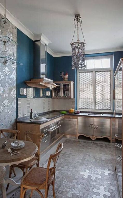The deep blue wall in this kitchen interior matches well with the elegant kitchen decor. A cylindrical chandelier illuminates this kitchen offering natural wood cabinetry with stainless steel doors and drawers. It includes a hanging glass rack and sleek vent hood. Get more eclectic kitchen decoration ideas in our collection. #kitchen #interior #eclectic (LGD) Courtesy of  Валентина Савескул Kitchen Interior, Interior Design Kitchen, Design, Kitchen Equipment, Modular Kitchen Design, Kitchen Design, Kitchen Designs Layout, Kitchen Styling, Eclectic Kitchen Design