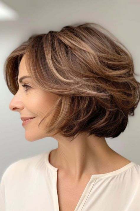 Opt for a voluminous chin-length bob to add an air of sophistication. Thick hair gives this bob a natural lift, no teasing is required. Click here to check out more flattering hairstyles for women over 50 with thick hair. Haircut For Thick Hair, Chin Length Bob, Chin Length Haircuts, Medium Length Hair Styles, Bob Haircut For Fine Hair, Chin Length Hair, Haircuts For Medium Hair, Bob Hairstyles For Thick, Thick Wavy Hair