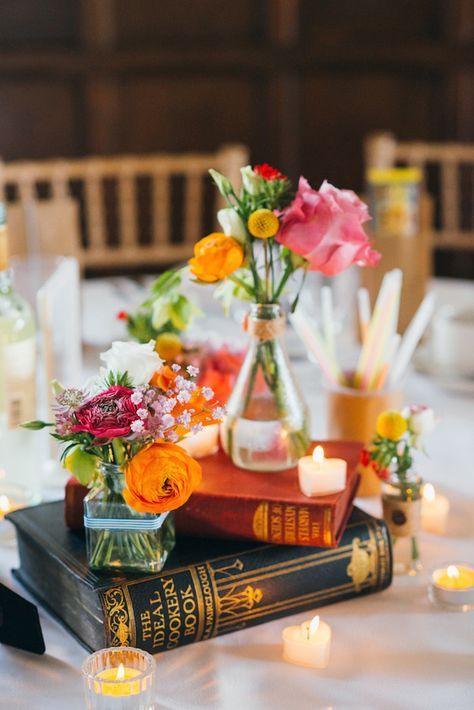 Pretty vintage books repurposed as colorful centerpieces… | 19 Gorgeous Things Every Book Lover Needs For Their Wedding Wedding Decor, Centrepieces, Wedding Centrepieces, Vintage Table Centerpieces, Wedding Buffet Table Decor, Book Wedding Centerpieces, Wedding Reception Tables Centerpieces, Creative Wedding Centerpieces, Table Decorations