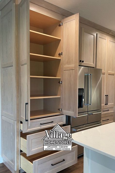 image of light white oak kitchen design with doors and drawers open on tall pantry cabinet. Black and white Village Home Stores logo in lower third of pin image. Interior, Home, Built In Pantry Cabinet Wall, Tall Pantry Cabinet, Tall Kitchen Pantry Cabinet, Built In Pantry, Small Pantry Cabinet, Kitchen Pantry Cabinets, Pantry Cabinet