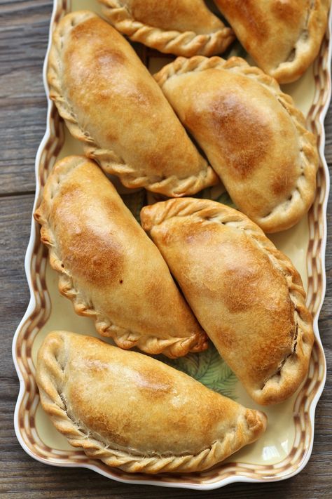 These fabulous traditional Argentinian Beef Empanadas Tucumanas feature a crispy dough encasing tender, flavorful filling. The hand-held turnovers are baked, yielding a less messy and lighter alternative to fried variations. The additions of hard-boiled eggs and scallions take this beef filling up a notch. Mexican Food Recipes, Beef Empanadas, Beef Empanadas Recipe, Argentinian Food, Baked Empanadas, Empanadas Recipe, Easy Empanadas Recipe, Empanadas Recipe Dough, Argentina Food