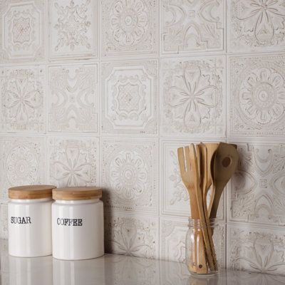 Reminiscent of antique tin ceiling tiles, our Fitz Ceramic Wall Tile offers authentic vintage appeal. This decorative square tile features embossed old-world motifs with splashes of glossy glazing. With a textured, mixed finish surface, this ceramic tile can blend into virtually any design theme, ranging from contemporary projects to traditional installations. Available in 40 print variations that are randomly scattered throughout each case, the variation throughout each tile mimics an authentic Printed Tile Backsplash Kitchen, Wall Tiles Design Kitchen, Wall Tiles Kitchen Backsplash Ideas, Merola Tile Kitchen, White Embossed Tiles, White Texture Tile Backsplash, Backsplash Kitchen Vintage, Backsplash Kitchen Color, Backsplash Square Tile