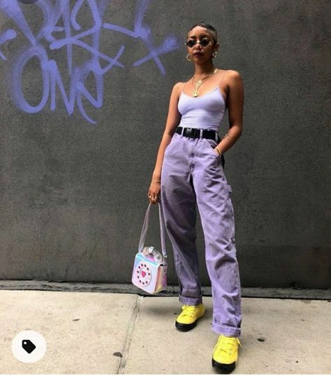 Purple and lavender street wear with neon yellow boots and telephone hand bag.