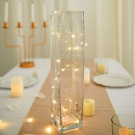 Decorate your special day with square cylinder glass vases from BalsaCircle.com! Handcrafted of clear glass, these tall vases are great for weddings, parties, events or simply using it in your own home. Vases are made from heavy duty glass and are a top choice for flower shops and wedding planners. Accent them with a variety of flowers, beads, filler balls or candles to create eye-catching centerpieces for your special occasions. WHAT YOU GET: Each order is for twelve (12) glass vases. Measurements: Height: approx. 14 inches tall. Opening: approx. 3.15 inches wide. Glass walls thickness: approx. 4mm. Material: Glass. Each vase is hand-crafted, some slight variations between each may occur. This purchase is for vases only. Lights and other decorations are not included. PLEASE NOTE: This ite
