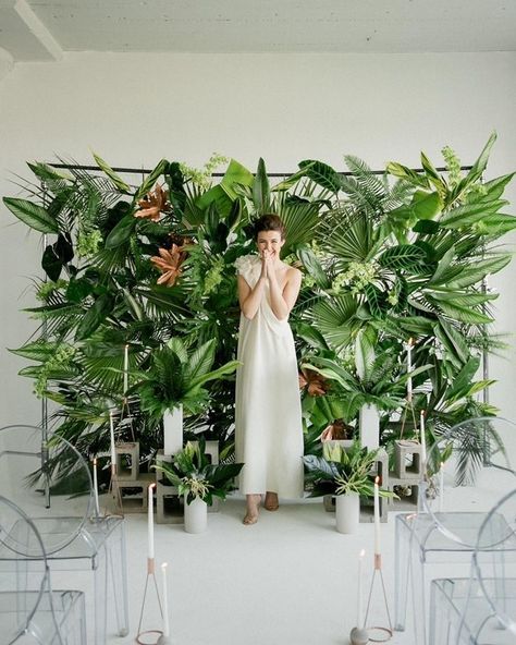 For something tropical with a modern, edgier twist, we love this ceremony backdrop constructed from loads of verdant tropical foliage. Concrete cinderblocks at the base display taper candles while the translucent ghost chairs round out this modern ceremony look. Wedding Decorations, Wedding Receptions, Aisle Decorations, Ceremony Backdrop, Wedding Ceremony Backdrop, Reception Flowers, Wedding Backdrop, Photo Booth Backdrop Wedding, Wedding Reception