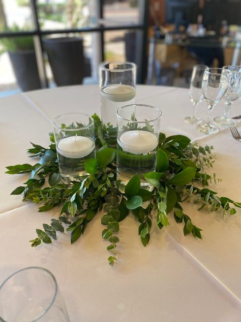 Greenery centerpiece, simple centerpiece, wedding, candles Floating Candles With Eucalyptus, Simple Banquet Centerpieces, Simple Green Centerpiece Wedding, Greenery Centerpiece Round Table Simple, Floating Candles With Flowers, Greenery And Candle Centerpiece, Floating Candles Centerpieces, Floating Candles Wedding Centerpieces, Eucalyptus Candle Centerpiece