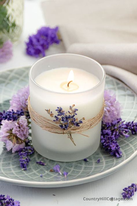 How to make your own DIY lavender soy candle at home! This homemade scented hand poured candles recipe has aromatherapy benefits. The easy natural candle making tutorial is great for beginners includes tips and tricks for supplies list, equipment, dried flowers, storage, mason jars, how to scent with essential oil blends or fragrance oils eg lemon or vanilla, packaging ideas, care tips and free printable labels. DIY lavender candles are cute handmade gift or for sale. | CountryHillCottage.com Diy, Mason Jars, Scented Soy Candles, Scented Candles, Homemade Lavender Candles, Soy Candle Making, Aromatherapy Candles, Lavender Soy Candle, Candle Making Tutorial