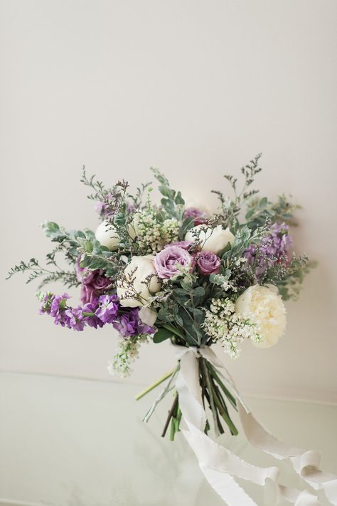 A gorgeous, organic, garden-inspired bouquet featuring lavender stock, lavender spray roses, lavender limonium, white peony, white lilac, and pearl acacia. Photo: Allie Siarto + Co. Photography #weddingbouquet #bridalbouquet #eastlansingbride #eastlansingwedding #lavenderbouquet #purplebouquet #whitepeony #whitepeonybouquet #peonybouquet #bouquettails #bouquetribbon #lavenderflowers #lavenderfloral #lavenderandwhite #lavenderwedding #greenerywedding #greenerybouquet #gardenbouquet Floral, Wedding Flowers, Wedding, Hochzeit, Hoa, Perfect Wedding, Bloemen, Bridal Flowers, Boda