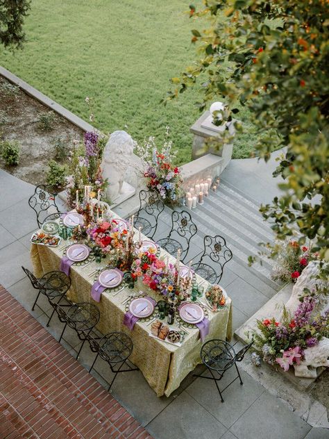 Welcome to the enchanting Wrensmoor Castle, an exquisite Los Angeles estate wedding venue that sets the stage for an unforgettable Maximalist Al Fresco Dinner Party, brought to you by Art & Soul Events. Get ready to indulge in a luxurious, one-of-a-kind dining experience under the stars. The dinner table was set with colorful garden blooms, hand-painted taper candles, candelabras, damask linens, velvet napkins, patterned china, and bookmark-style name cards/menus. Photographer: Victoria Gold Los Angeles, Fresco, Wedding Venues, Castle Party, Secret Garden Wedding, California Wedding Venues, Estate Wedding Venue, Wedding Table Designs, Wedding Table
