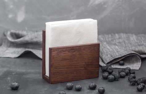 Stylish napkin holder stand made of top quality oak will add some warmth and coziness into your interior. This option of t able napkin holder is universal, as it is suitable for standard and big size ones. Bar napkin holder is perfect for both dining and festive table.  Rustic napkin holder can be made in 5 colors options: natural oak, light oak, dark oak, cherry oak, bleached oak. The size of the compartment for paper napkins 4,9 inch.  Size: 5,7x5,7x3,1 inch. Diy, Decoration, Design, Dekorasyon, Couple Gifts, Deko, Kayu, Rak Kayu, Minis