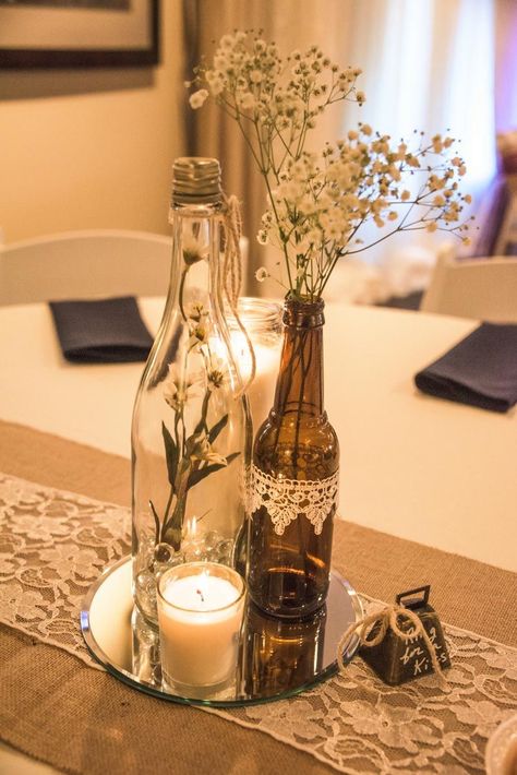 Wine bottle vases sitting atop of a round mirror with votive candle rests on a burlap & lace table runner, complete with a bell to "ring for a kiss." Wine Bottle Crafts, Diy Wedding Decorations, Wine Bottle Centerpieces, Wine Bottle Vases, Wine Bottle Diy Crafts, Bottle Centerpieces, Wedding Wine Bottles, Wedding Centerpieces Diy, Bottle Candles