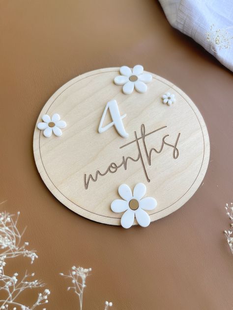 "Baby Milestone  Capture those Monthly Milestone of your little one with our Monthly Milestone Daisy style wooden Disc.  ever Moth is so precious it is worth a shot and with our stylish milesone you can record every months as your baby grows  DETAILS *6\" round  plaque. *Engraved on 1/8 Birch Plywood.  *2 Disc ( month & Months) along with 12 Acrylic cut Numbers which are interchange 1-12  *       Glue Dot to attach each numbers monthly *Slight variations in color may be a result due to the natur Baby's First Birthday, Baby Milestone Cards, Baby Monthly Milestones, Baby Grows, Baby First Birthday, Milestone Cards, Boho Baby, Baby Month By Month