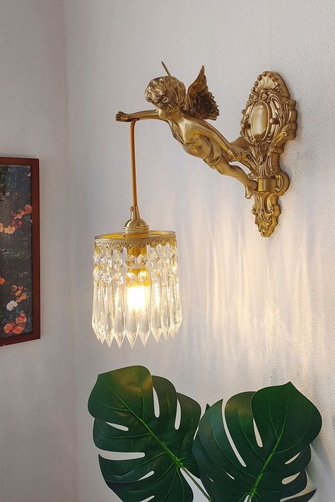 This elegant of statuary wall lamp adds a touch of charm to any room. Handmade by our skilled artisans, this fixture includes a putti little angel. The detailing is breathtakingly realistic and highlights the handiwork applied to this piece. From a functional standpoint, this makes for a very durable and functional lighting component. Therefore it donates a warm premium look to your home. Also it easily combines with lots of colors. Note: If you need to buy two, please buy the size with this (se Home Décor, Bedroom Vintage, Crystal Wall Lighting, Wall Lamp, Lamp, Crystal Wall, Bedroom Lighting, Light Fixtures, Gold Gallery Wall