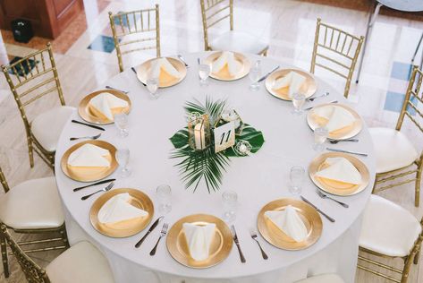Modern Classic Tropical Wedding Reception Decor, Round Tables with White Linens, Gold Chiavari Chairs, Gold Chargers, Monstera Palm Tree Leaf Centerpiece and Geometric Candle Holders | Wedding Photographer Kera Photography | St. Pete Wedding Venue The Poynter Institute Decoration, Wedding Centrepieces, Tropical Wedding Centerpieces, Tropical Centerpieces, Wedding Centerpieces, Tropical Wedding Decor, Tropical Wedding Reception Decor, Tropical Wedding Theme, Tropical Wedding Reception
