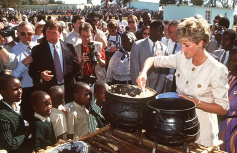 Princess Diana helps to serve food at the Nemazura feeding centre - a Red Cross project for refugees - in Zimbabwe, in July 1993