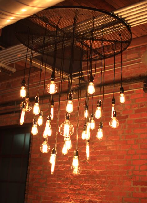 An industrial look, Edison bulb chandelier by Get Lit, Special Event Lighting.  Installed here at Bay 7, American Tobacco Campus, Durham. Ea, Vintage, Studio, Design, Edison Bulb Light Fixtures, Edison Bulb Lighting Wedding, Hanging Bar Lights, Industrial Chandelier, Exposed Bulb Lighting