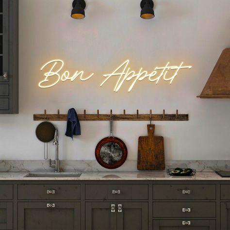 "Bon Appetit Custom LED neon sign for kitchen wall decor D E T A I L S * LED neon sign. * Transparent acrylic backboard with hanging holes. * 7 feet (2m) transparent wire from sign to power adaptor (we can lengthen by request). What else it comes with? * Remote dimmer controller. * 3 feet power adaptor cord with a plug of your country. * Hanging kit - screws. * Good vibes (read further) I T ' S * A W E S O M E * We use LED neon for our signs which looks fabulous. - see reviews for proofs * Neon Decoration, Neon, Home Décor, Led Neon Signs, Custom Neon Signs, Led Signs, Neon Light Signs, Custom Neon Lights, Custom Wall
