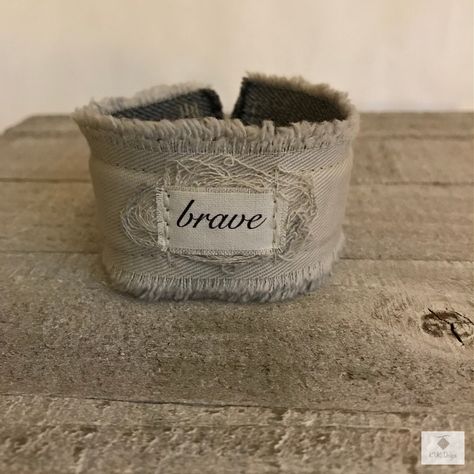"Quote: BRAVE A soft comfortable cuff with layers of sandstone beige cotton fabric that are stitched together. Pile of threads cushion the epithet. Text printed on colorfast fabric and ink is heat set for durability. Easily cleans w a wet one. This cuff closes with a vintage button & a stretchy loop. Measurements: 7\" L by 1 1/2\" W Fits a wrist size approximately 6 3/4\" to 8\" Bracelet fit wrists: S, M, L Always fits a smaller wrist just a bit looser. If you have a wrist smaller then 6 3/4\" p Boho, Bijoux, Fabric Cuff Bracelets Diy, Boho Cuff Bracelet, Cuff Bracelets Diy, Fabric Cuff Bracelet, Cuff Bracelets, Fabric Bracelets, Cuff Bracelet