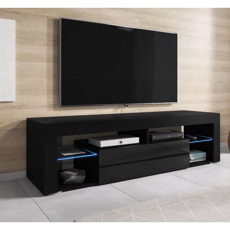 Zipcode Design <p>This highly contemporary TV stand is a functional focal point for your living space. It can accommodate televisions up to 60 inches in size, and includes open shelves and a storage compartment for electronics and additional media. Two of the shelves include integrated lighting to enhance the modern feel of this piece of furniture. Assembly required.</p><strong>Features:</strong><ul><li>Available in various colours</li><li>Dimensions: 140cm x 36cm height x 40cm depth</li><li>Fin 2 Drawer Tv Stand, Contemporary Tv Stand, Tv Stands, Tv Stand, Tv Unit, Tv Furniture, Living Room Tv Stand, Tv Unit Design, Living Room Tv Unit Designs