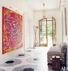 A painting by Yayoi Kusama commands a wall in the entrance hall/gallery, which is paved with Carrara, Bleu de Savoie, and Nero Marquina marbles in a graphic pattern | archdigest.com Design, Interior, Desi, Dekorasyon, Resim, Styl, Hol, Modern, Gang