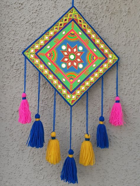 A simple, easy and colorful wall hanging craft idea. I have made it using waste cardboard. Painted it with acrylic colors and decorated with 3D outliners, yarn and some mirrors. This festive season add some colors to your home with this craft idea, its super easy to make. Mandalas, Diy Wall Art, Design, Wall Hanging Crafts, Wall Hanging Diy, Diy Wall Hanging Crafts, Diy Wall Hanging, Wall Decor Crafts, Handmade Wall Hangings
