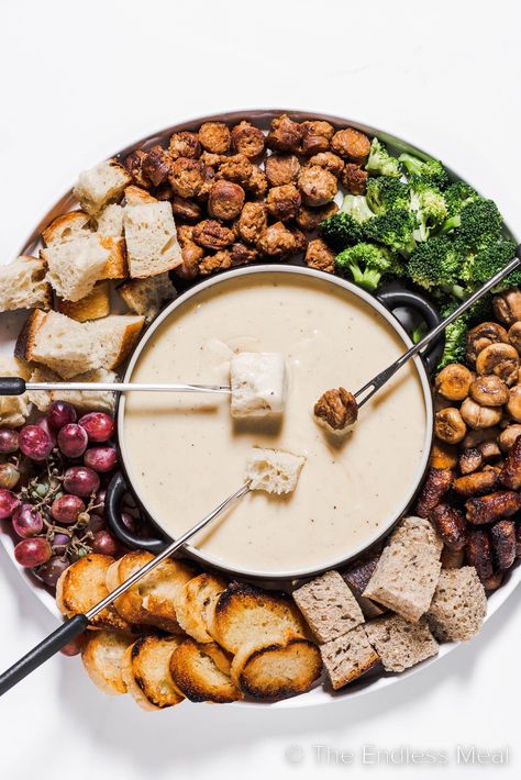 This cheese fondue is creamy, smooth, and by far the best! It's classic melted gruyère cheese flavored with caramelized shallots, apple brandy, and warm spices. It's an easy recipe that's perfect for seasonal gatherings, and it's ready in just 35 minutes! #theendlessmeal #fondue #cheesefondue #nye #cewyearseve #appetizer Dips, Cheese, Cheese Fondue, Gruyere Cheese, Gruyere Cheese Recipe, Cheese Flavor, Cheese Recipes, Fondue Recipes Cheese, Fondue Dinner
