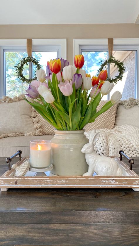 Tulips styled in a crock on a tray with a white ceramic bunny and a candle on the coffee table in front of the sofa with windows behind it. Inspiration, Home Décor, Decoration, Spring Home Decor, Spring Home, Summer Home Decor, Spring Decor, Spring Kitchen Decor, Spring Summer Decor