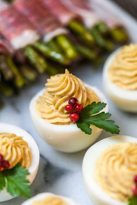 These merry little Christmas deviled eggs are so cute, so festive and incredibly tasty! All you need are a few pink pepper corns and a few parsley leaves to make these jolly appetizers. #christmas, #deviledeggs, #appetizers, #christmasfood, #christmasrecipe Snacks, Christmas Appetizers, Christmas Treats, Christmas Snacks, Christmas Food, Christmas Baking, Christmas Cooking, Christmas Food Dinner, Xmas Food