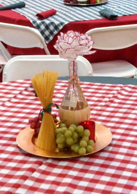 These were the centerpieces we used for an Italian Theme Event. We used real grapes, a chianti bottle, dry pasta and a candle on a charger. And the flower in the chianti bottle was made out of a coffee filter. HSO Dinner Party Decorations, Dinner Centerpieces, Italian Table Decorations, Italian Party Decorations, Dinner Decoration, Italian Themed Parties, Italian Dinner Party Decorations, Dinner Party Themes, Italian Centerpieces