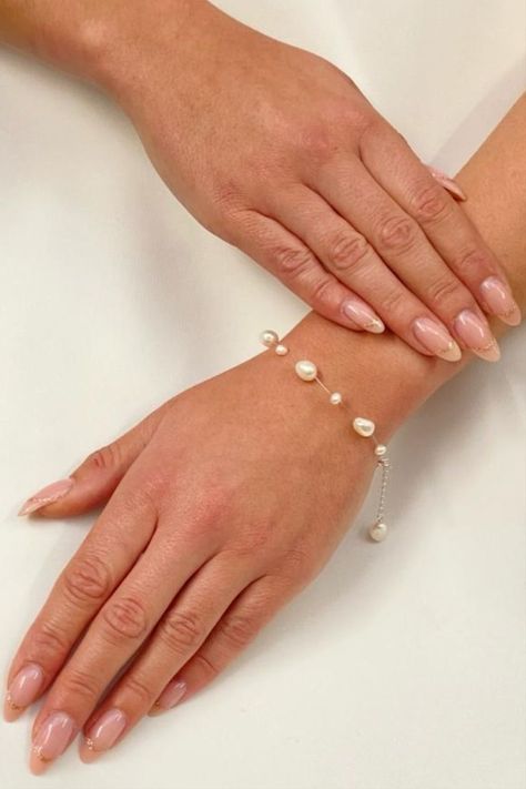 Genuine ivory freshwater pearls dotted on transluscent wire gives the illusion of floating pearls on the wrist. Made with varying size pearls this bracelet has a dainty extension chain finished with a pearl drop. The perfect wedding jewellery piece for brides looking for something a little different! #weddingjewellery #bridaljewellery #bridesmaidjewellery #braceletsforwomen Engagements, Wedding Dress, Pearl Bracelet Wedding, Pearl Jewelry Wedding, Pearl Jewelry, Pearl Wedding Bracelet Brides, Pearl Bracelets, Wedding Jewelry Bracelets, Pearl Bracelet