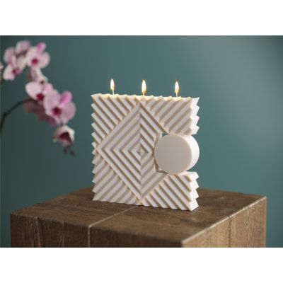 RHOMBUS Pillar Candle is made to impress. This candle features a bold usage of geometrical shapes with a full moon circle, three wicks and unscented finish. Simplicity of lines in combination with a custom natural beeswax and soy wax blend bring a charismatic ambience to your space. Each candle is individually hand molded by a Candle Sculptor. | Orren Ellis 62DBDE88C6D94C18819FCDDF089013CE Pillar Candle Beeswax / Soy in White, Size 5.7 H x 5.7 W x 1.7 D in | Wayfair Diy, Pretty, Mariage, Deco, Aesthetic, Geometric Candles, Manualidades, Hand Molding, Modern Candles