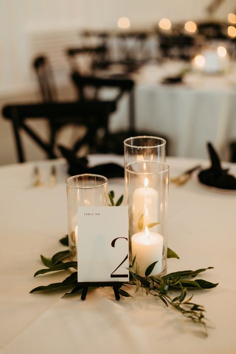 A romantic grouping of hurricane candles on top of  sprigs of greenery is a perfect touch to this elegant and modern wedding reception.

- Olivia Doerfler Photography Engagements, Wedding, Bride, Elegant, Engagement, Classy Wedding, Boda, Hochzeit, Mariage