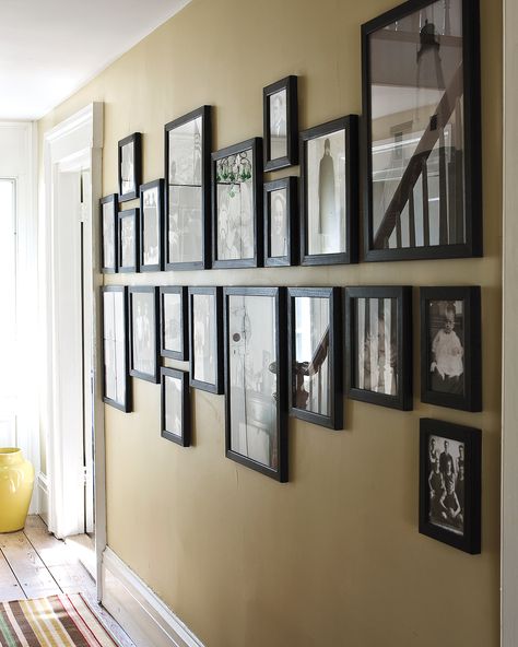 12 Brilliant Ways to Decorate a Blank Wall | A blank wall is like a blank canvas—it's filled with possibilities. What better way to make use of the walls in your home than to celebrate the loved ones who fill it? In this setting, a set of family photographs are unified with identical black frames. The arrangement trick also further elongates the length of the wall.  #homedecor #wallart #marthastewart #diydecor Interior, Diy Interior, Home Décor, Ikea, Room Decor, Interieur, Home Decor, Home Diy, Wall Decor Living Room