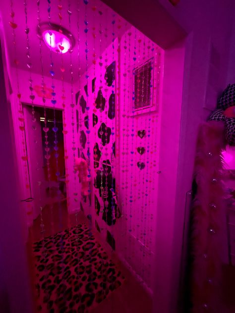 colorful neon apartment with beaded door curtain and cow print doors