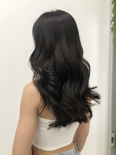 Long black hair styled with curls