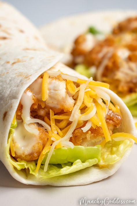 Air fryer snack wrap filled with breaded chicken, romaine lettuce, shredded Cheddar Jack cheese, and ranch dressing on a light gray plate. Apps, Desserts, Chicken Snack Wrap, Chicken Snack Wrap Recipe, Crispy Chicken Sandwiches, Crispy Chicken Wraps, Mcdonalds Chicken Snack Wrap, Crispy Chicken, Chicken Snacks