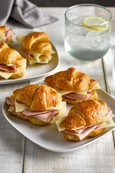 A plate with croissants filled with sliced ham and cheese on a table. Croissant, Brunch, Croissants, Ham And Cheese Sandwich, Ham And Cheese Croissant, Ham And Cheese, Croissant Breakfast Sandwich, Cheese Croissant, Ham Sandwiches