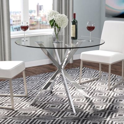 Anchor your dining space in sleek, contemporary style with this striking dining table. Crafted of clear tempered glass with a rounded edge, the 0.4" thick tabletop strikes a 41.3" W x 41.3" D circular silhouette. Sporting a gleaming chrome finish, an architectural X-frame steel base features flat square platforms to accommodate the tabletop and felt foot pads to save your floors from scratches and scuffs. Perfect for intimate dinners and family feasts alike, this table comfortably seats up to fo Dining Chairs, Design, Dining Room Table, Dining Room Decor, Dinning Room Tables, Dining Room Design, Dining Table Decor, Dining Table, Dining Room Small