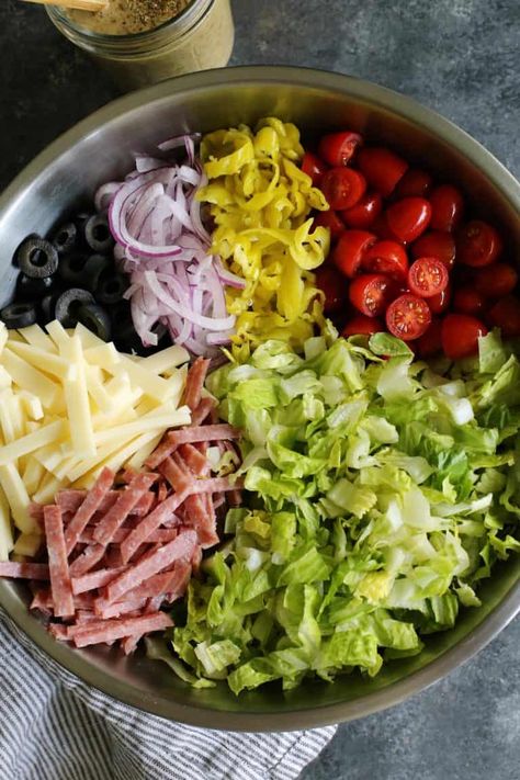 Italian Chopped Salad from afarmgirlsdabbles.com - an Italian salad loaded with fresh goodness, plus salami, provolone, pepperoncini, and olives. It's light, yet hearty, and extra flavorful with a zippy Italian vinaigrette! #salad #italian #chopped #lettuce #tomatoes #onion #salami #provolone #pepperoncini #olives Snacks, Kale, Fresh, Salmon, Summer Salads, Quinoa, Fruit Salad, Vinaigrette, Healthy Recipes