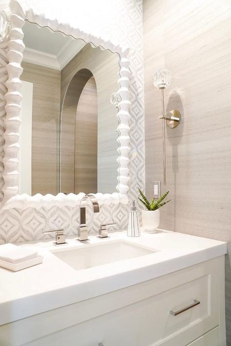 This beautifully fitted bathroom features an Oly Studio Clyde Mirror hung from an accent wall clad in white and gray mosaic tiles over a white dresser-like washstand. Inspiration, Interior, Home, Bathroom, Home Décor, Bathrooms Remodel, Coastal Powder Room, White Vanity Bathroom, White Bathroom
