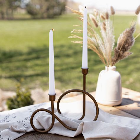 This Curvy Candle Holder features a unique twisted shape in a brass finish that's perfect for mantle displays, centerpieces and tray designs. The on-trend, modern curved design adds soft, rounded edges to your room decor with its transitional style. Featured here with our 12" Taper Candle Pair Dimensions: 10.25" x 4.25" x 8.75" Materials: metal