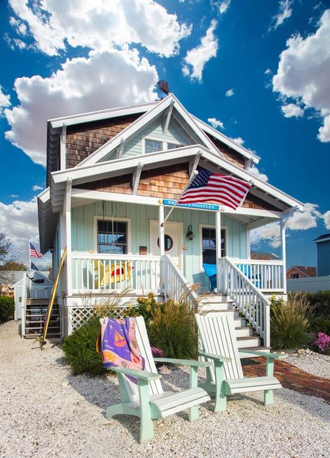 A porch swing and wooden chairs adorn the porch space of this small surfer cottage near the New Jersey shore. Photo by Scot Zimmerman. Beach Cottages, Camping, Beach Cottage Style, East Coast, Coastal Homes, Beach Cottage Decor, Utah Style, Beach Shack, Summer Porch