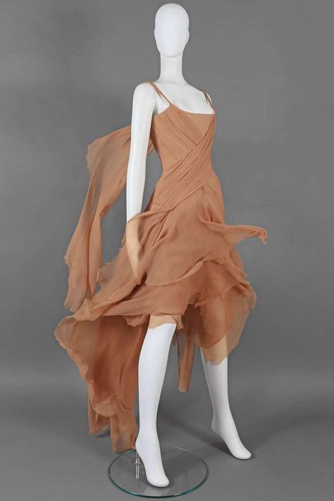 For Sale on 1stdibs - Exquisite and rare Alexander McQueen nude silk chiffon evening gown for the 'Irere' Spring-Summer 2003 collection. The dresses features a corsetted inner