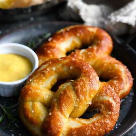 The best homemade soft pretzels are soft, buttery, slightly sweet, and easy to make from scratch with ingredients that you probably already have on hand. This soft pretzel recipe is perfect for serving as a snack or party appetizer, or as a delicious side dish with soup or chili for dinner. Don't forget the honey mustard and cheese dip! Snacks, Breads, Muffin, Dessert, Desserts, Mixers, Homemade Soft Pretzels, Pretzels Recipe, Pretzel Dough
