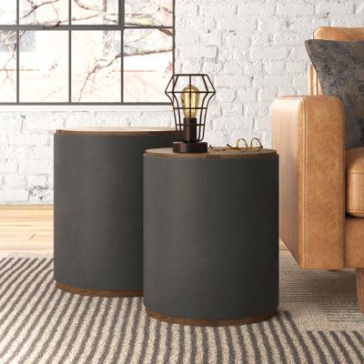 This 2-piece set of nesting tables gives your living area sleek, modern silhouettes and platforms for accent lamps, magazines, and your favorite beverages. Shaped cylindrically, each table is wrapped in black metal with a solid wood top and lower section that add a bit of contrast and rustic flair to this industrial-inspired design. We love how the finish of the wood brings out its natural graining to complete the look. The largest of the tables has a diameter of 19", so it saves on space wherev Home Décor, Nesting End Tables, Nesting Tables, End Table Sets, End Tables, Wood Console Table, Wooden Tops, Drum Coffee Table, Rustic Accent Table
