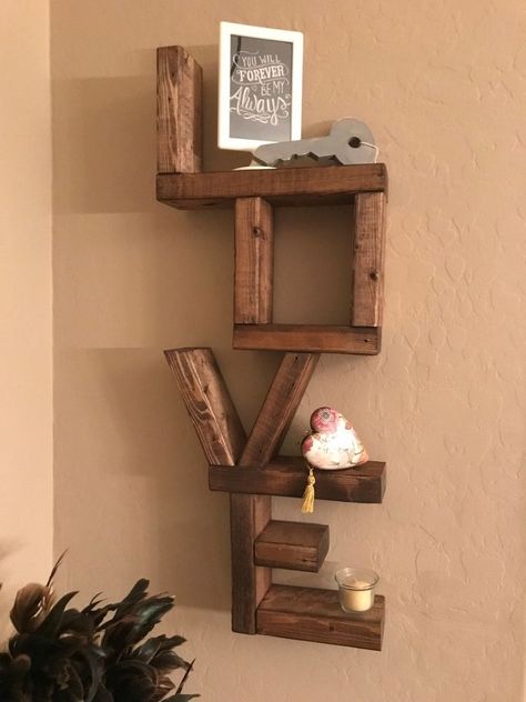 I saw this shelf on Pintrest a while ago and wanted to make it. As soon as the season for Valentine's was coming , I started the shelf. I decided I wanted to make a few at a time. As I'm sure I'd sell or use them as gifts. I asked by Hubby to help. On Friday, I drew up various designs based off of pictures of various LOVE shelves that I had seen. Then, I decided how tall I wanted the shelf to be and came up with the other dimensions. I had a wood pall… Diy, Valentines Diy, Things To Sell, Valentine Wood Crafts, Affordable Diy Ideas, Dekoration, Wood Gifts, Love Shelf, Crafts To Sell
