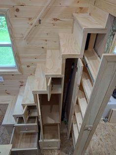 These Tiny House Stairs have plenty of storage. Three drawers, a large storage compartment, a broom closet, a pull-out pantry, and two small cupboards. Staircase With Room Under, Tiny Cabin Space Saving Ideas, Storage Shed Laundry Room, Stairs Straight Up, Alternative Bathtub Ideas, Tiny Loft Bedroom Ideas, Small Room Couch Ideas, Diy Shed House Floor Plans, Portable Cabin Interior