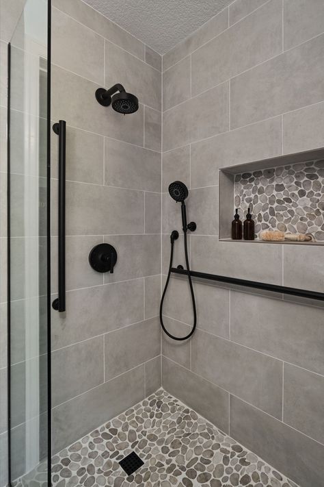 A transitional shower design with river rock floor and large format grey tile on the walls. Matte black fixtures. Home Décor, Master Bath Shower Tile, Shower Floor Tile Ideas, Shower Ideas Bathroom Master Baths, Master Shower Tile, Bathroom Shower Tiles, Shower Floor Tile, Bathroom Shower Tile, Bathroom Shower Walls